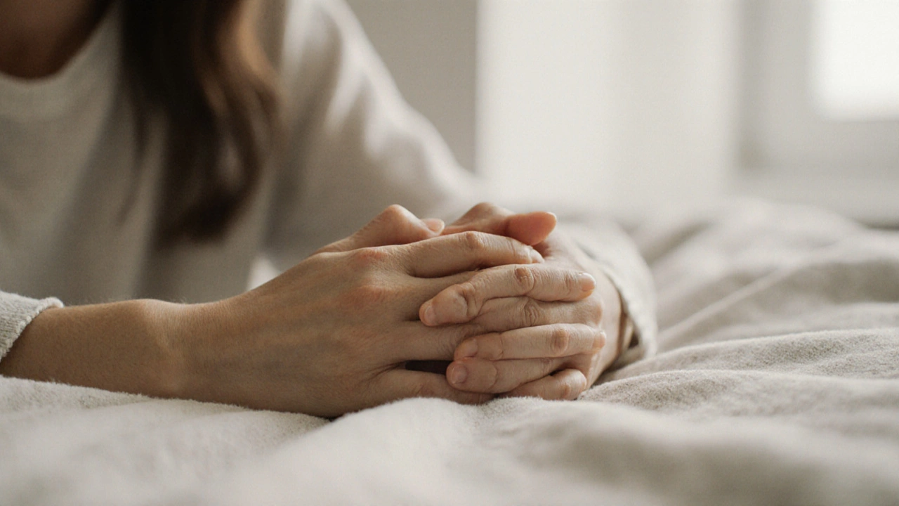 Intertwined hands resting on a blanket, conveying gentle connection and calm.