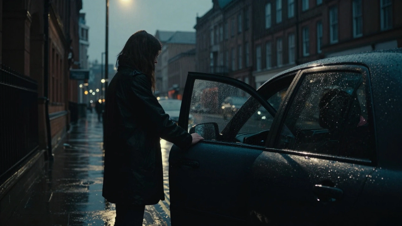 A person standing alone by a car in the rain at night, suggesting a discreet meeting.