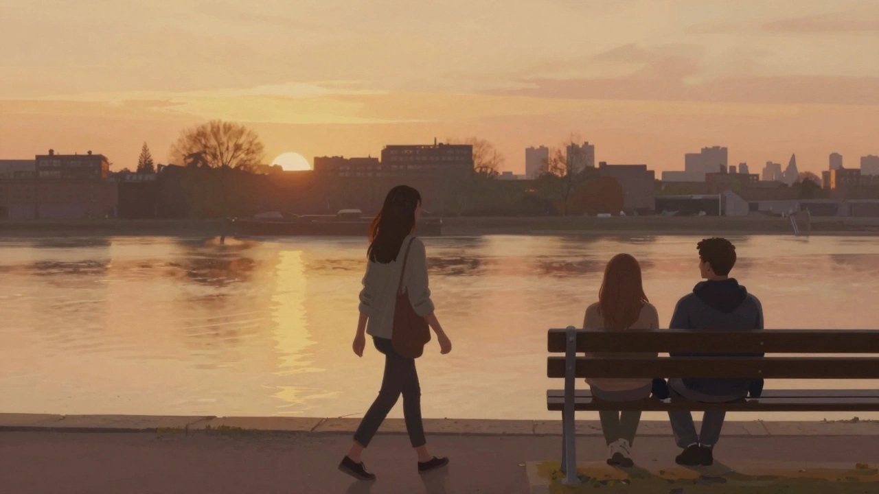A woman and man walking beside the Thames at sunset, dressed casually, no touching.