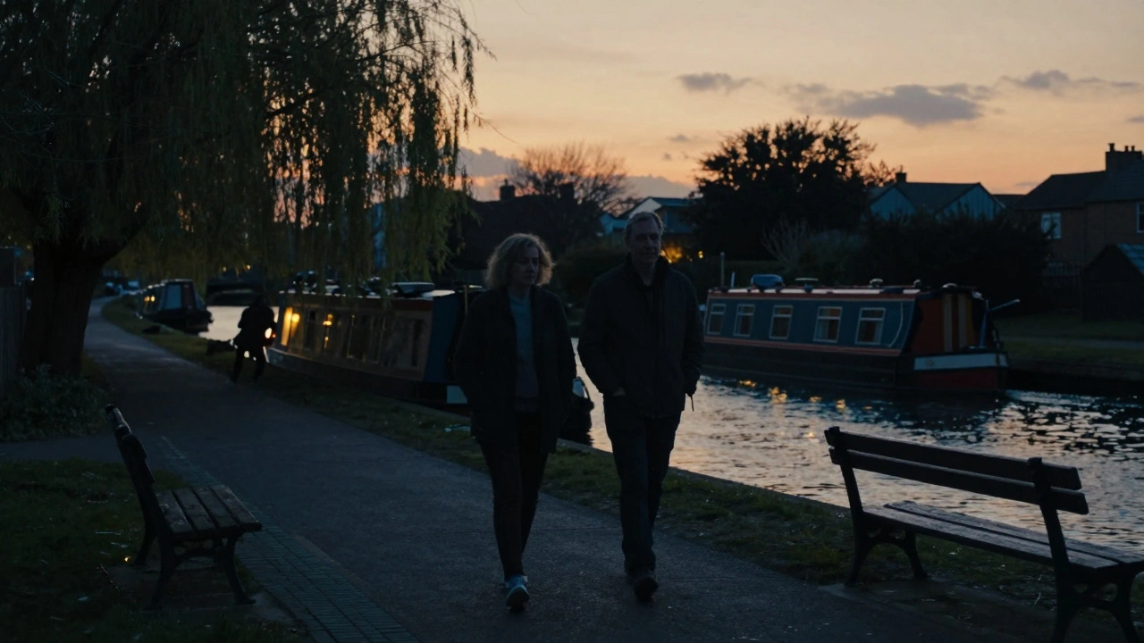 Two people walking peacefully along the Regent’s Canal at dusk, silhouetted against the sunset.